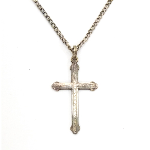 710 - Six assorted cross / cruciform pendants on chains, to include some silver examples. Largest pendant ... 