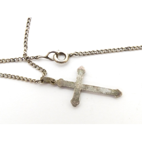 710 - Six assorted cross / cruciform pendants on chains, to include some silver examples. Largest pendant ... 