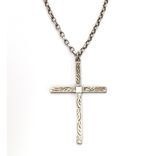 710 - Six assorted cross / cruciform pendants on chains, to include some silver examples. Largest pendant ... 