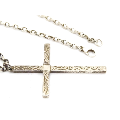 710 - Six assorted cross / cruciform pendants on chains, to include some silver examples. Largest pendant ... 