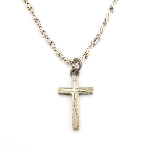 710 - Six assorted cross / cruciform pendants on chains, to include some silver examples. Largest pendant ... 