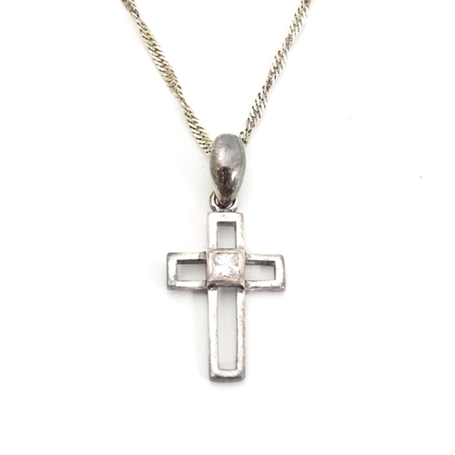 710 - Six assorted cross / cruciform pendants on chains, to include some silver examples. Largest pendant ... 