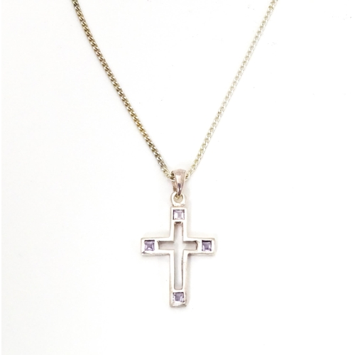 710 - Six assorted cross / cruciform pendants on chains, to include some silver examples. Largest pendant ... 