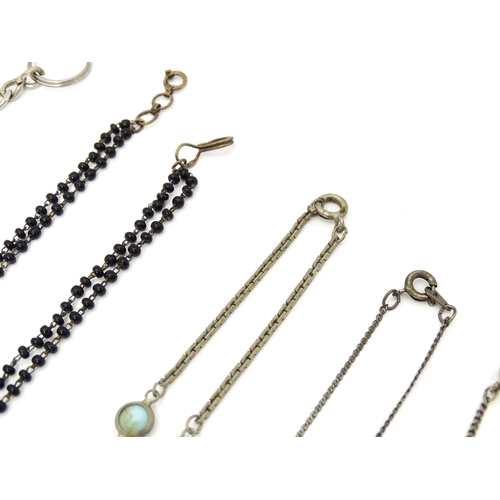 723 - Assorted jewellery to include silver chains, pendants, yellow metal bow formed brooch with garnet ca... 