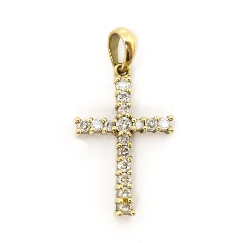 735 - A 9ct gold cross form pendant set with diamonds. Approx. 1