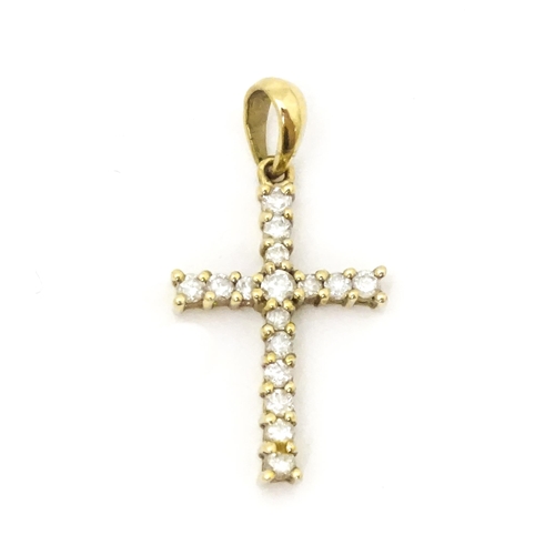 735 - A 9ct gold cross form pendant set with diamonds. Approx. 1