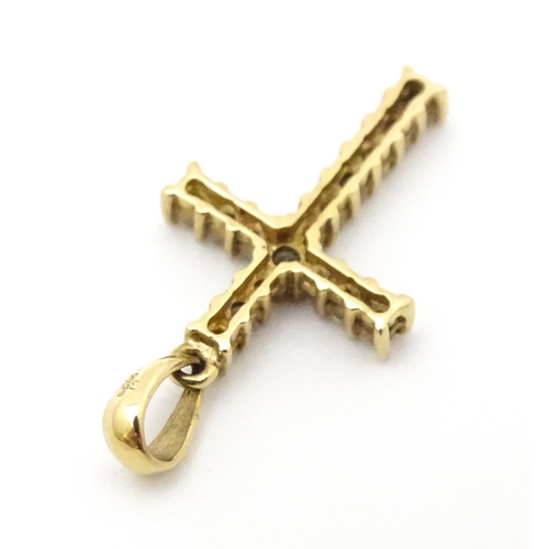 735 - A 9ct gold cross form pendant set with diamonds. Approx. 1