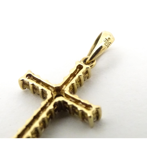 735 - A 9ct gold cross form pendant set with diamonds. Approx. 1