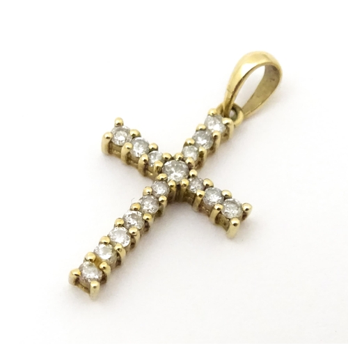 735 - A 9ct gold cross form pendant set with diamonds. Approx. 1