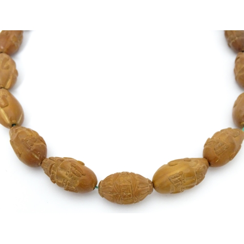 739 - An Oriental necklace of Hediao carved nut beads. Approx. 23