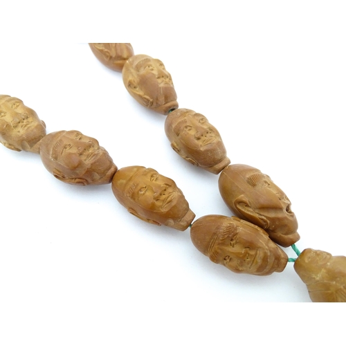 739 - An Oriental necklace of Hediao carved nut beads. Approx. 23