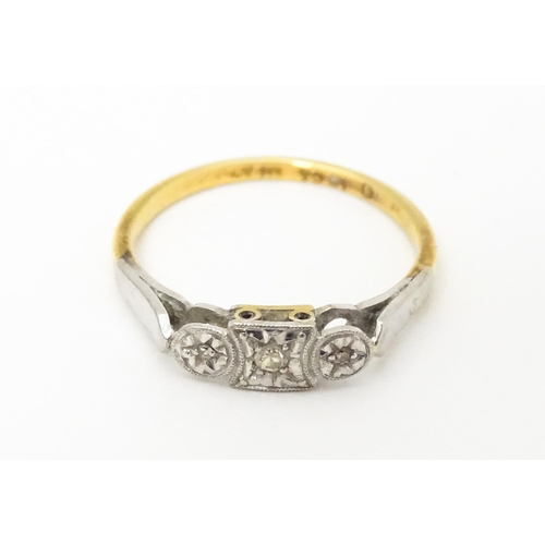 746 - An 18ct gold ring set with three diamonds. Ring size approx. M