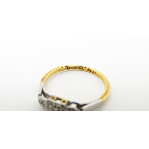 746 - An 18ct gold ring set with three diamonds. Ring size approx. M