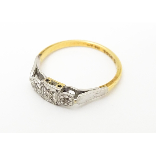 746 - An 18ct gold ring set with three diamonds. Ring size approx. M