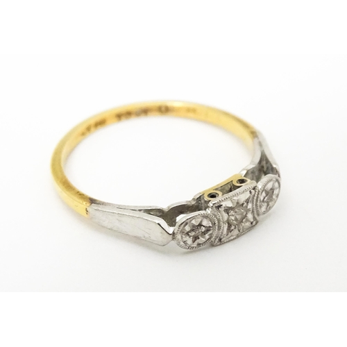 746 - An 18ct gold ring set with three diamonds. Ring size approx. M