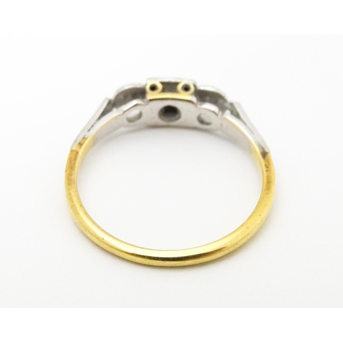 746 - An 18ct gold ring set with three diamonds. Ring size approx. M