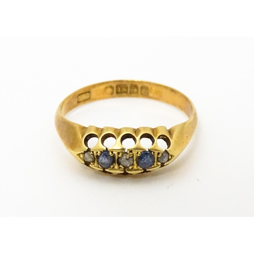 747 - An 18ct gold ring set with sapphires and diamonds. Ring size approx. N 1/2