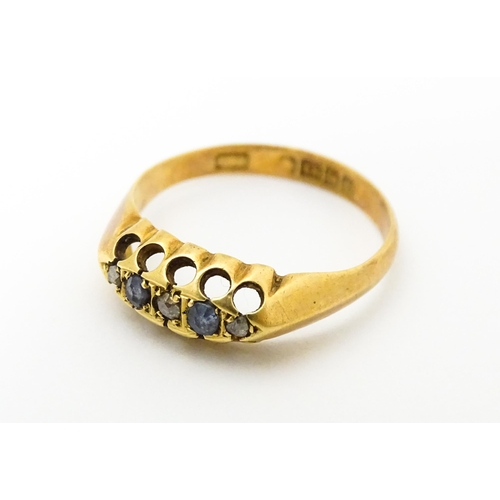 747 - An 18ct gold ring set with sapphires and diamonds. Ring size approx. N 1/2