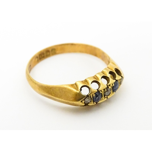 747 - An 18ct gold ring set with sapphires and diamonds. Ring size approx. N 1/2