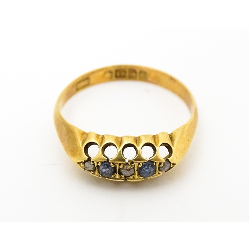 747 - An 18ct gold ring set with sapphires and diamonds. Ring size approx. N 1/2