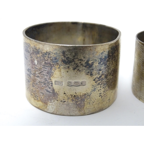 335 - A silver napkin ring hallmarked Sheffield 1928, maker Atkin Brothers. Together with another having e... 