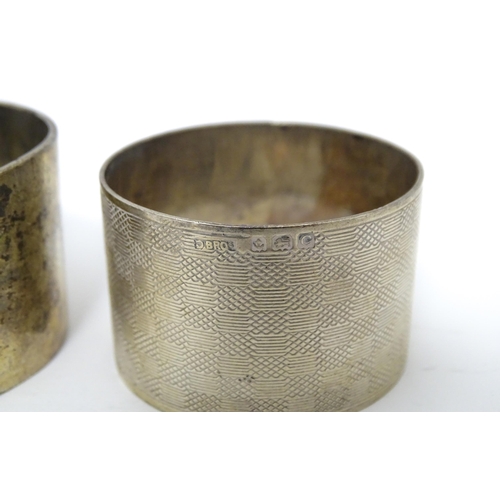 335 - A silver napkin ring hallmarked Sheffield 1928, maker Atkin Brothers. Together with another having e... 