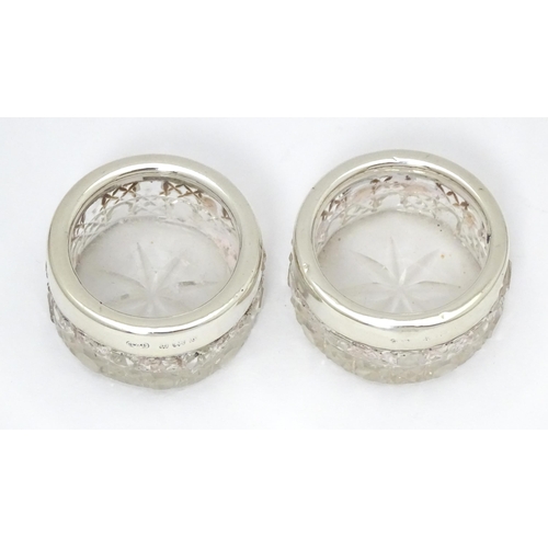 338 - A pair of cut glass salts with silver rims, hallmarked Birmingham 1901, maker Synyer & Beddows. Appr... 