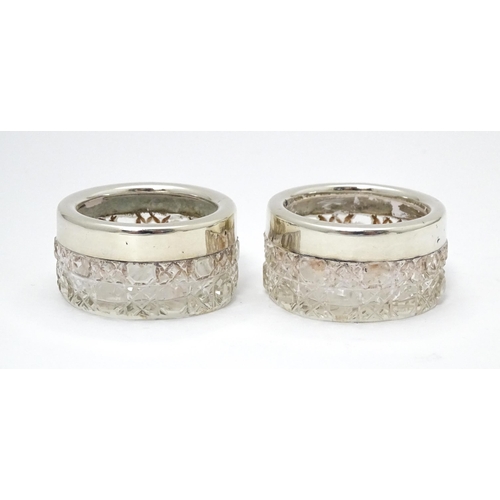 338 - A pair of cut glass salts with silver rims, hallmarked Birmingham 1901, maker Synyer & Beddows. Appr... 