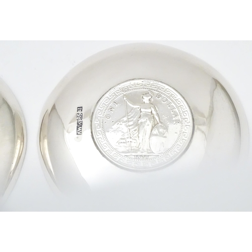 341 - A pair of white metal pin dishes with hammered decoration and inset coin medallions to base. Possibl... 