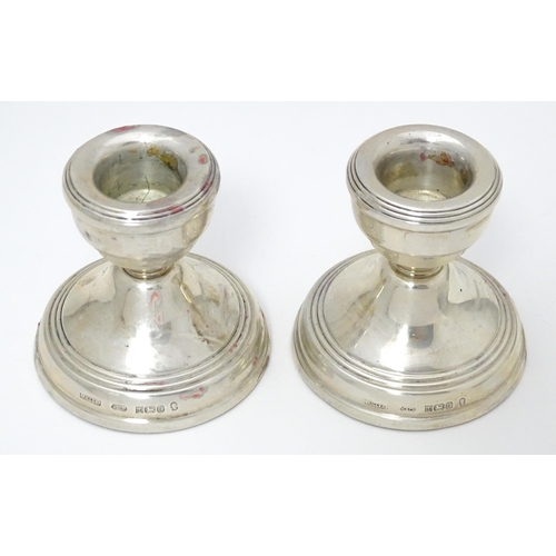 343 - A pair of short silver candlesticks hallmarked Birmingham 1977 with Silver Jubilee mark, maker W. I.... 