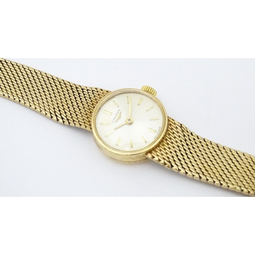 772 - A ladies 9ct gold cased Longines wristwatch with 9ct gold strap. Watch dial approx. 5/8