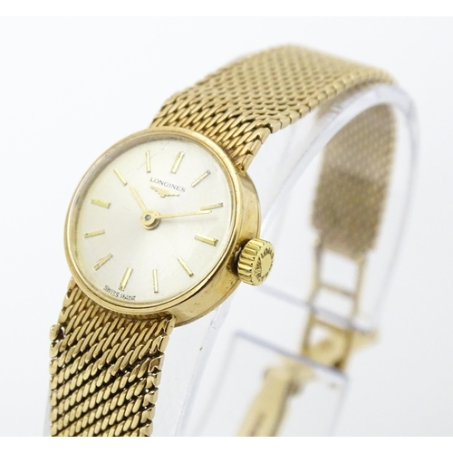 772 - A ladies 9ct gold cased Longines wristwatch with 9ct gold strap. Watch dial approx. 5/8