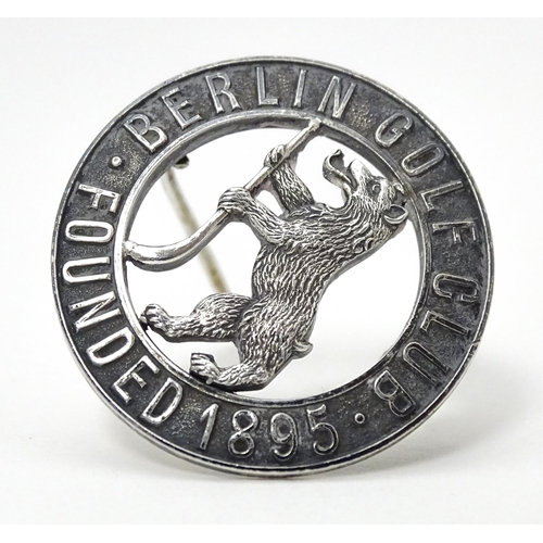 776 - Three assorted items comprising white metal badge titled Berlin Golf Club Founded 1895, a silver bad... 