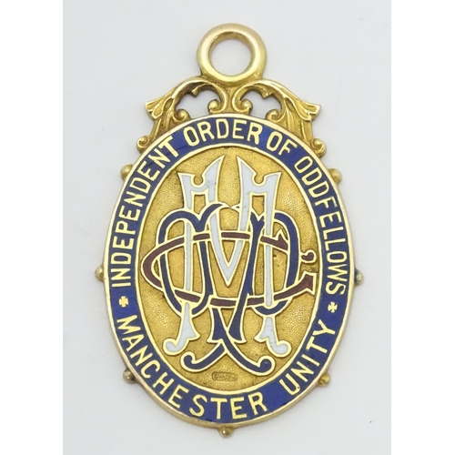 777 - A Victorian 9ct gold pendant / fob with enamel detail titled Independent Order of Oddfellows Manches... 