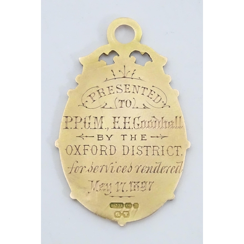 777 - A Victorian 9ct gold pendant / fob with enamel detail titled Independent Order of Oddfellows Manches... 