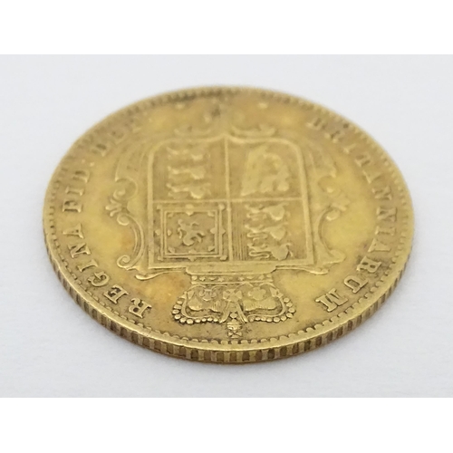 778 - Coin: A Victorian 1869 gold half sovereign coin. Approx. weight 4g. Together with a coin formed fob ... 