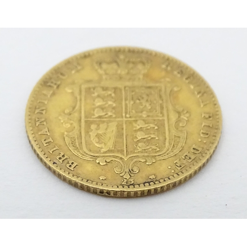 778 - Coin: A Victorian 1869 gold half sovereign coin. Approx. weight 4g. Together with a coin formed fob ... 