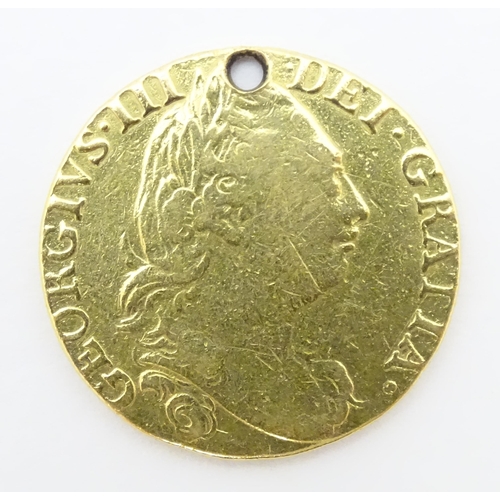 778 - Coin: A Victorian 1869 gold half sovereign coin. Approx. weight 4g. Together with a coin formed fob ... 