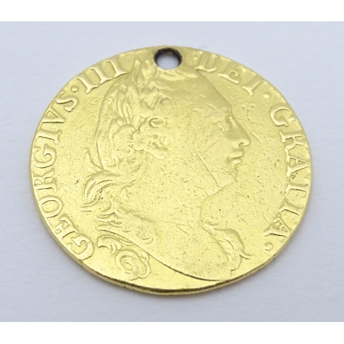 778 - Coin: A Victorian 1869 gold half sovereign coin. Approx. weight 4g. Together with a coin formed fob ... 