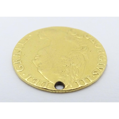 778 - Coin: A Victorian 1869 gold half sovereign coin. Approx. weight 4g. Together with a coin formed fob ... 