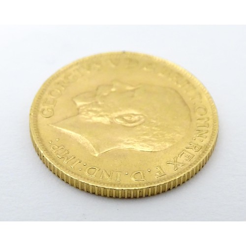 779 - Coin: A George V 1912 gold sovereign coin. Total weight approx. 8g