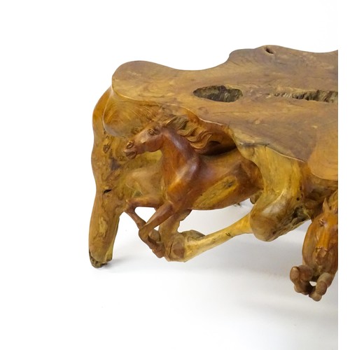 1328 - A mid 20thC root carved coffee table, with galloping horses populating the exterior of the table and... 