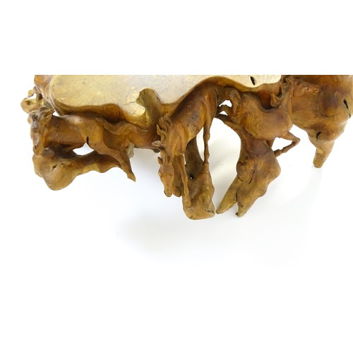 1328 - A mid 20thC root carved coffee table, with galloping horses populating the exterior of the table and... 