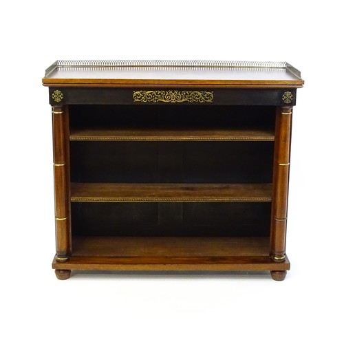 1335 - A 19thc mahogany bookcase surmounted by a brass gallery and with inlaid brass decoration. The bookca... 