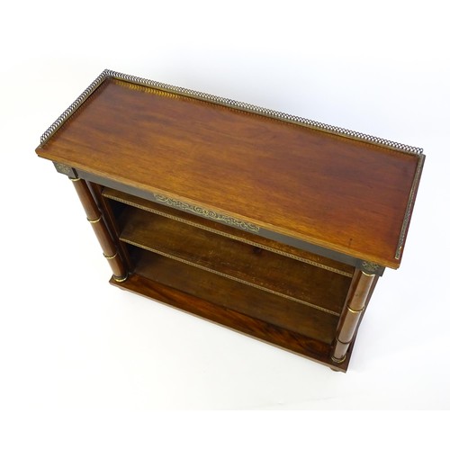 1335 - A 19thc mahogany bookcase surmounted by a brass gallery and with inlaid brass decoration. The bookca... 