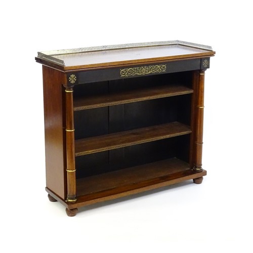 1335 - A 19thc mahogany bookcase surmounted by a brass gallery and with inlaid brass decoration. The bookca... 