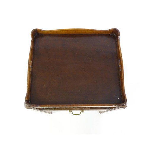 1338 - A late Georgian mahogany tray top table with pierced handles and a tambour front above a single shor... 