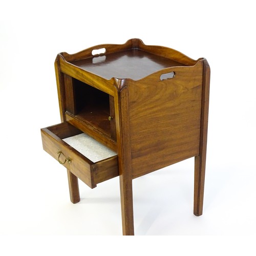 1338 - A late Georgian mahogany tray top table with pierced handles and a tambour front above a single shor... 