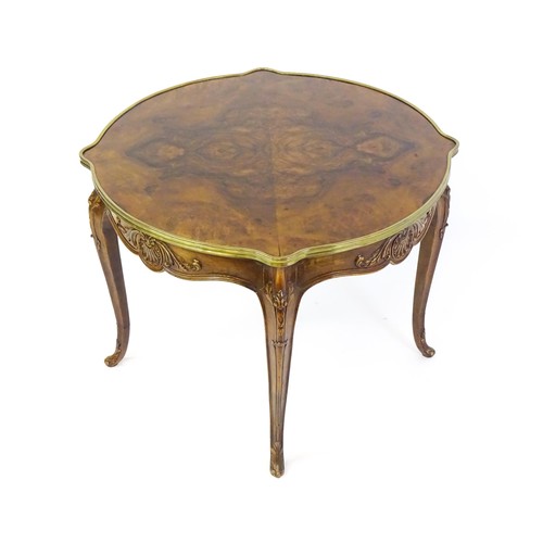 1341 - A late 19thC / early 20thC walnut centre table with a shaped top and a gilt surround, the table havi... 