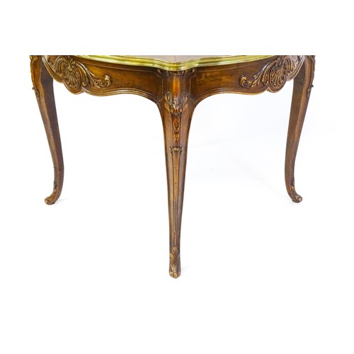 1341 - A late 19thC / early 20thC walnut centre table with a shaped top and a gilt surround, the table havi... 